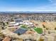 An aerial view of a school surrounded by homes and mountains in the distance on a sunny day at 187 Cerillos St, Brighton, CO 80601