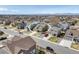 Aerial view of a home in a residential area with surrounding houses and well-maintained lawns on a sunny day at 187 Cerillos St, Brighton, CO 80601