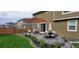 Beautiful backyard patio with pergola, stylish outdoor furniture, and a well-manicured lawn, perfect for relaxing and entertaining at 187 Cerillos St, Brighton, CO 80601