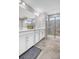 Bathroom featuring double vanity, large mirror, and glass-enclosed shower at 187 Cerillos St, Brighton, CO 80601