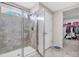 Modern bathroom featuring glass shower and entry to a walk-in closet at 187 Cerillos St, Brighton, CO 80601