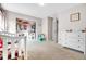 Well-lit bedroom with plush carpeting, white furniture, and a tidy closet at 187 Cerillos St, Brighton, CO 80601