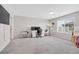 Spacious carpeted bedroom with a well-lit desk area and large window at 187 Cerillos St, Brighton, CO 80601
