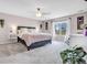 Comfortable bedroom with a ceiling fan, large window with curtains, and stylish decor at 187 Cerillos St, Brighton, CO 80601