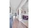 Elegant hallway with hardwood floors and French doors leading to a sitting room at 187 Cerillos St, Brighton, CO 80601