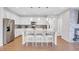 Open kitchen with granite countertops, stainless steel appliances, a spacious island, and a tiled backsplash at 187 Cerillos St, Brighton, CO 80601