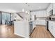 Bright kitchen boasts stainless appliances, a center island with barstool seating, and granite countertops at 187 Cerillos St, Brighton, CO 80601