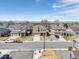 A street view of multiple two-story homes, each with well-maintained lawns and driveways, creating a welcoming neighborhood atmosphere at 187 Cerillos St, Brighton, CO 80601