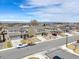 A street view of multiple two-story homes, each with well-maintained lawns and driveways, creating a welcoming neighborhood atmosphere at 187 Cerillos St, Brighton, CO 80601