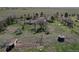 Spacious land featuring a lovely ranch home with outbuildings, set amid rolling green fields and mature trees at 7409 S County Road 157, Strasburg, CO 80136
