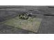 Aerial view of a large plot of land featuring a farm house surrounded by fields, dirt roads, and a few trees at 7409 S County Road 157, Strasburg, CO 80136