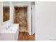 Bathroom featuring a tiled shower stall, modern sink, and a neutral color palette for a clean and modern look at 7409 S County Road 157, Strasburg, CO 80136