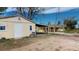 Exterior view showing a matching shed and basketball hoop, connected by a covered walkway to the single-story home at 7409 S County Road 157, Strasburg, CO 80136