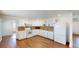Functional kitchen featuring white appliances, tiled backsplash, and ample cabinet space for storage at 7409 S County Road 157, Strasburg, CO 80136