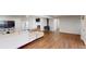 Spacious living room features a fireplace, wood floors, and access to the backyard at 7409 S County Road 157, Strasburg, CO 80136