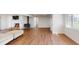 Bright living room boasts a stone fireplace and wood-look floors, creating a cozy yet spacious living area at 7409 S County Road 157, Strasburg, CO 80136
