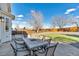 Inviting back patio with a dining table, perfect for outdoor gatherings and relaxation with views of the backyard at 7132 Eagle Rock Dr, Littleton, CO 80125