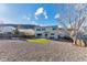 Spacious backyard with a large lawn, gravel landscaping, and a two-story home at 7132 Eagle Rock Dr, Littleton, CO 80125