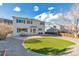 Spacious backyard featuring a stone patio, lush artificial grass, and low-maintenance gravel landscaping at 7132 Eagle Rock Dr, Littleton, CO 80125