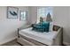 Cozy bedroom featuring a stylish daybed with teal pillows and decorative wall art at 7132 Eagle Rock Dr, Littleton, CO 80125