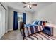 Bright bedroom with wood floors, blue bedding, and a ceiling fan at 7132 Eagle Rock Dr, Littleton, CO 80125