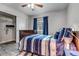 Bedroom featuring modern gray flooring, a wood-framed bed, and ample closet space at 7132 Eagle Rock Dr, Littleton, CO 80125