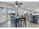 Bright dining area featuring wood floors, modern table set and sliding glass doors to the yard at 7132 Eagle Rock Dr, Littleton, CO 80125