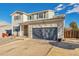 Charming two-story home featuring a gray two car garage, and low maintenance landscaping at 7132 Eagle Rock Dr, Littleton, CO 80125