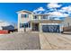 Charming two-story home featuring a gray two car garage, and low maintenance landscaping at 7132 Eagle Rock Dr, Littleton, CO 80125