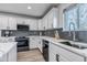 Well-appointed kitchen featuring modern appliances, sleek countertops, and stylish backsplash at 7132 Eagle Rock Dr, Littleton, CO 80125