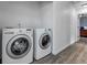 Functional laundry room featuring modern washer and dryer appliances at 7132 Eagle Rock Dr, Littleton, CO 80125
