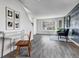 Bright living room with large window, accent wall, neutral furniture, and modern flooring at 7132 Eagle Rock Dr, Littleton, CO 80125