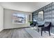 Stylish living room featuring a modern accent wall, large window, and sleek flooring at 7132 Eagle Rock Dr, Littleton, CO 80125