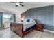 Charming main bedroom with wood floors, a paneled accent wall and a sleigh bed at 7132 Eagle Rock Dr, Littleton, CO 80125