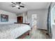 Spacious main bedroom featuring wood floors, a sleigh bed and an ensuite bathroom at 7132 Eagle Rock Dr, Littleton, CO 80125
