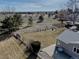 Aerial view of a large backyard with mature trees, a patio, and a fenced perimeter at 7160 S Jellison St, Littleton, CO 80128