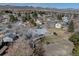 Aerial view of a single Gathering home with a fenced backyard and lush greenery in a quiet neighborhood at 7160 S Jellison St, Littleton, CO 80128
