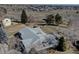 Aerial view of a single Gathering home with a grey roof and beautiful landscape at 7160 S Jellison St, Littleton, CO 80128