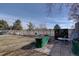Backyard featuring a lush garden, mature trees, and outdoor seating area at 7160 S Jellison St, Littleton, CO 80128