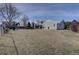 Large backyard with a patio dining set, mature trees, and ample lawn space at 7160 S Jellison St, Littleton, CO 80128