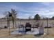 Backyard patio with outdoor dining set and potted plants, creating a cozy and inviting space at 7160 S Jellison St, Littleton, CO 80128