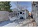 Backyard shed next to a dining set and a charming decorative fence with gardening decor at 7160 S Jellison St, Littleton, CO 80128