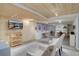 Basement space with wood ceiling, finished floors, media, and seating area at 7160 S Jellison St, Littleton, CO 80128