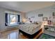 Cozy bedroom with large window seat, hardwood floors, and natural light at 7160 S Jellison St, Littleton, CO 80128