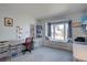 Bright office/bedroom with large windows and built-in desk, shelves, and storage at 7160 S Jellison St, Littleton, CO 80128