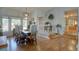 Elegant dining room featuring hardwood floors, chandelier lighting, and a large bay window at 7160 S Jellison St, Littleton, CO 80128