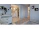Hallway leading to the bathroom with linen closet and vanity, offering a functional design at 7160 S Jellison St, Littleton, CO 80128
