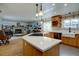 Open concept kitchen features an island with modern countertops and wooden cabinetry offering space for cooking and storage at 7160 S Jellison St, Littleton, CO 80128