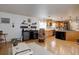 Open-concept living room with an eat-in kitchen offers a comfortable area with plenty of natural light at 7160 S Jellison St, Littleton, CO 80128