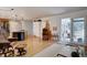 Bright living room featuring bar with kitchen access and access to a sunroom offers open space for relaxation and enjoyment at 7160 S Jellison St, Littleton, CO 80128